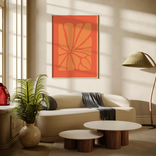 Large Geo Flower Wall Art Print in coral and orange. A modern botanical wall art design, framed and hanging on the wall of a stylish beige living room.