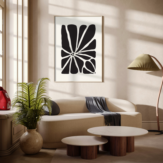 Large Geo Flower Wall Art Print in black. A modern botanical wall art design, framed and hanging on the wall of a stylish beige living room.